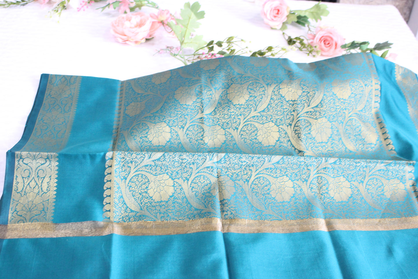 Party wear in Aqua blue color with an elegant gold Banarasi dupatta.