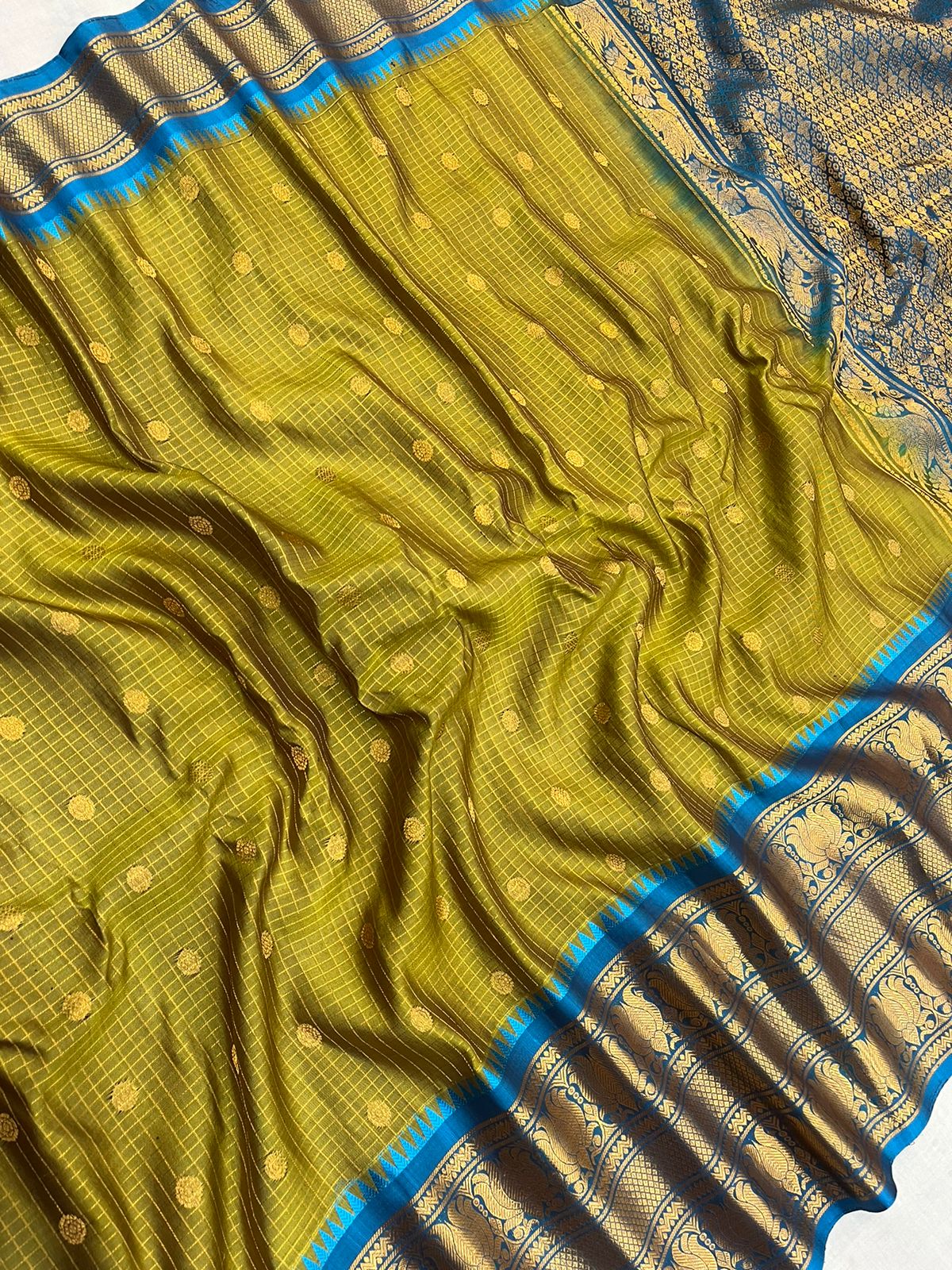 Beautiful mustard yellow and blue combination of pure Gadwal handloom with checks Pattu saree